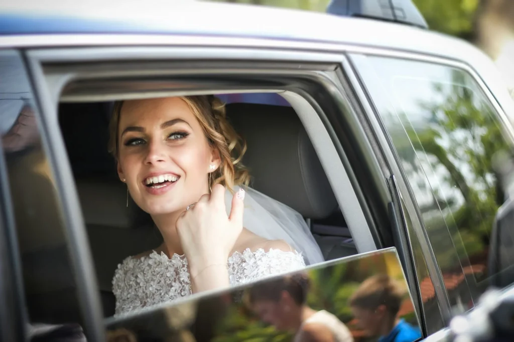 Bride smiling in the back seat of a wedding limousine in Los Angeles